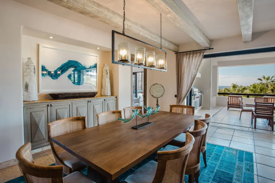 Villa dining room with long table and terrace doors at Esperanza.