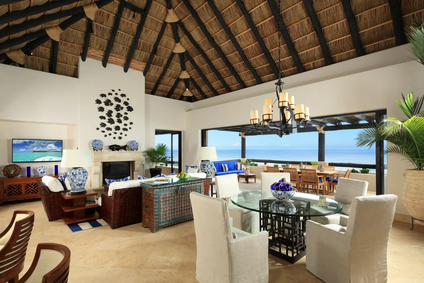 Villa living and dining room with palapa ceiling and ocean-view terrace at Esperanza.