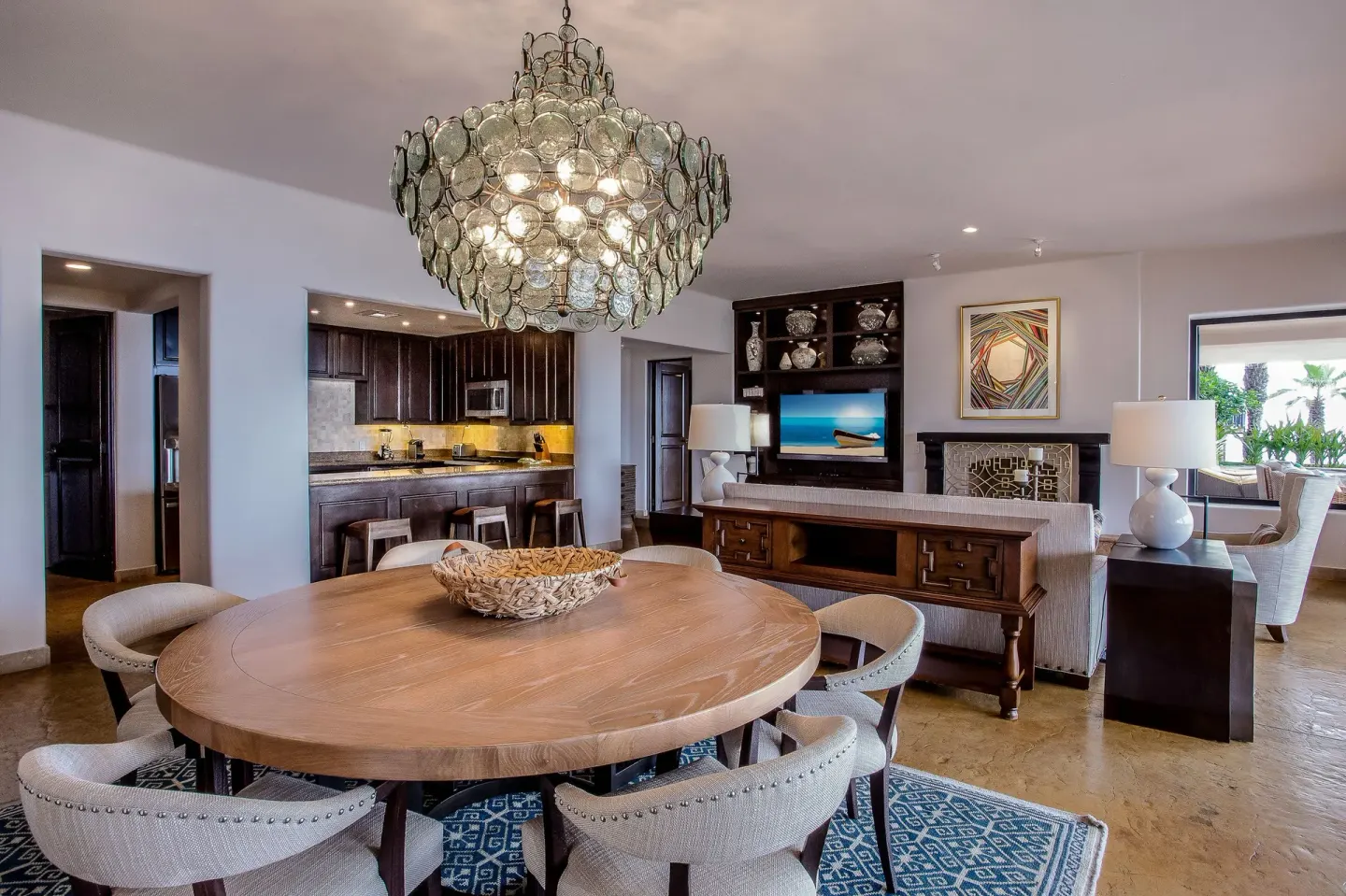 Villa dining and living area with kitchen and chandelier at Esperanza.