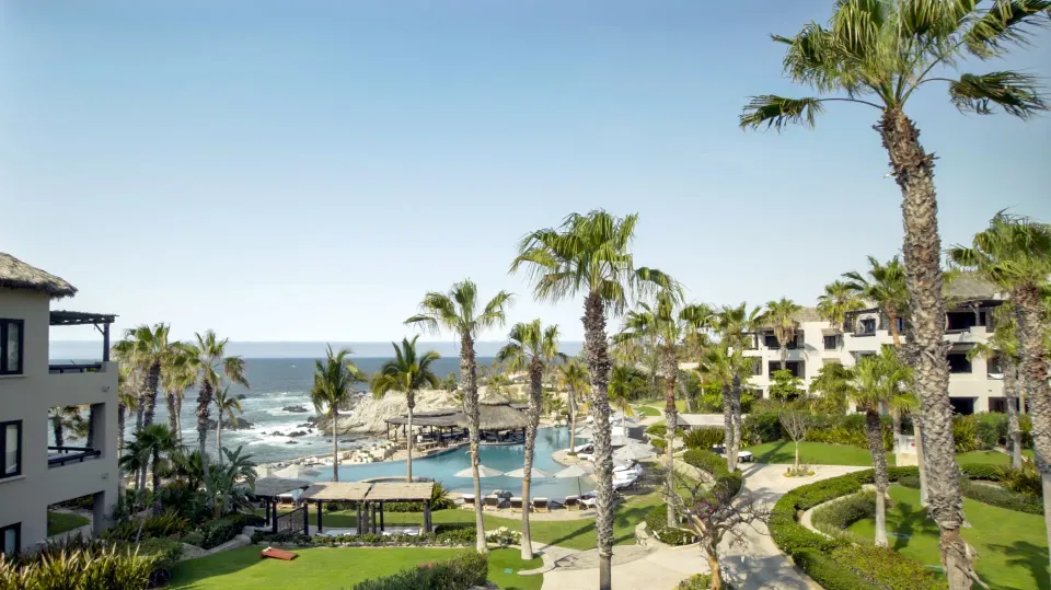 Villa ocean view over palms, pools, lawns, and resort buildings at Esperanza.