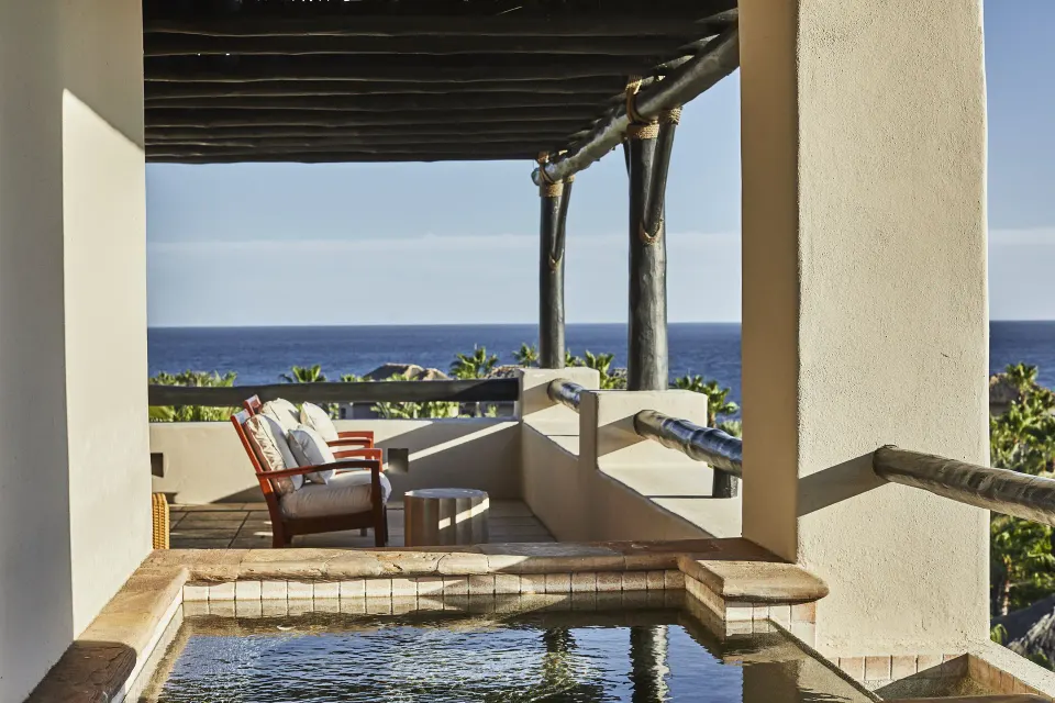 Villa hot tub terrace with lounge seating and ocean view at Esperanza.