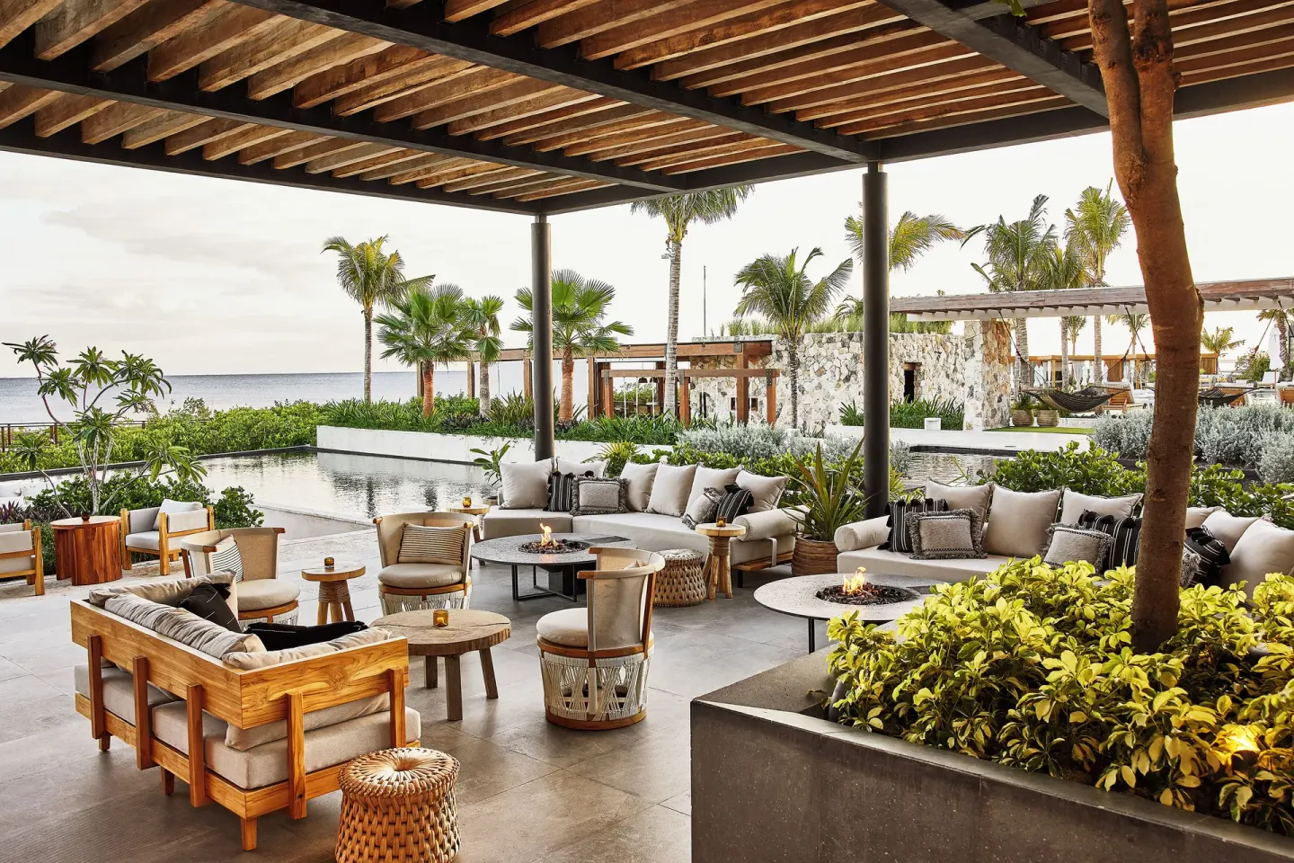 Covered lounge terrace with fire tables and ocean view at Etéreo, Auberge Collection.