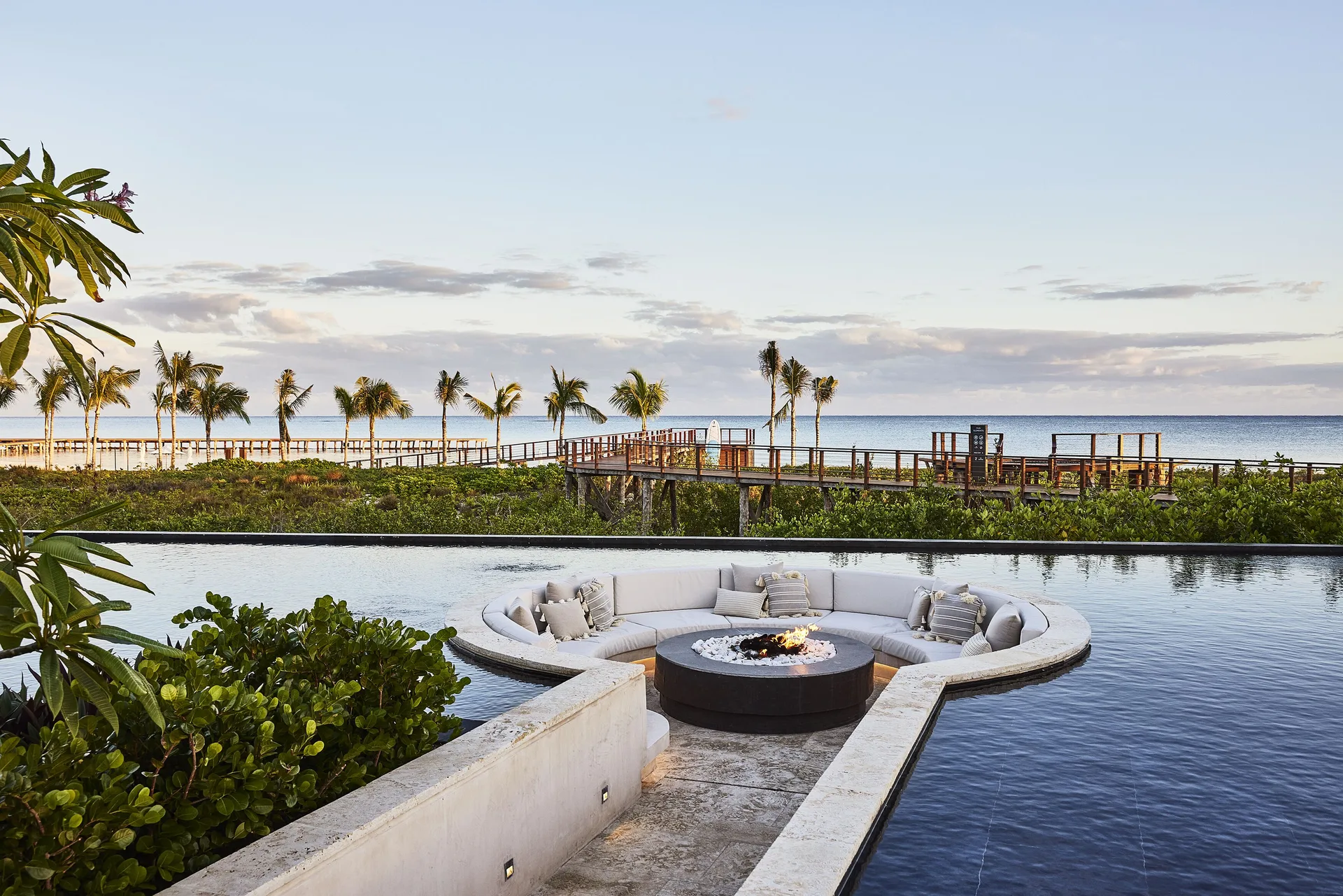 Fire pit lounge set within an infinity pool by the ocean at Etéreo, Auberge Collection.