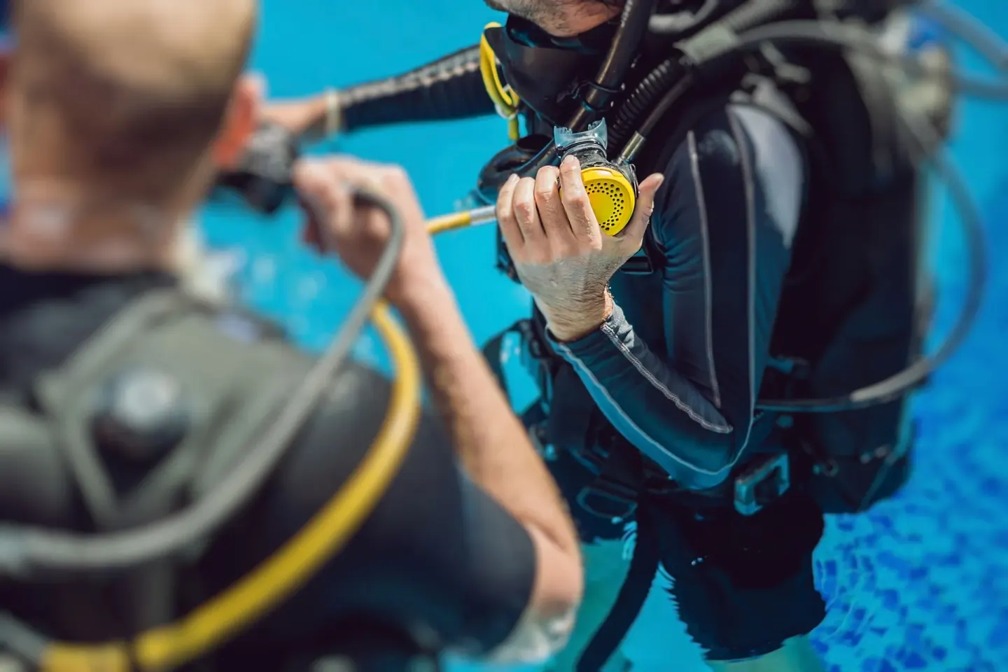 Two scuba divers practice underwater with regulators near Etéreo, Auberge Collection.