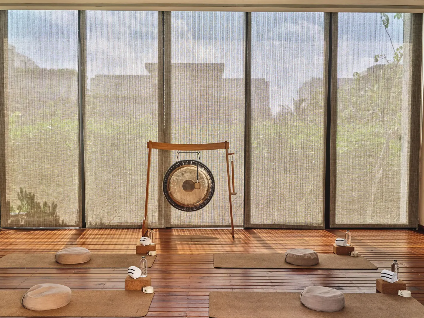 Meditation mats and a gong in a wellness studio at Etéreo, Auberge Collection.