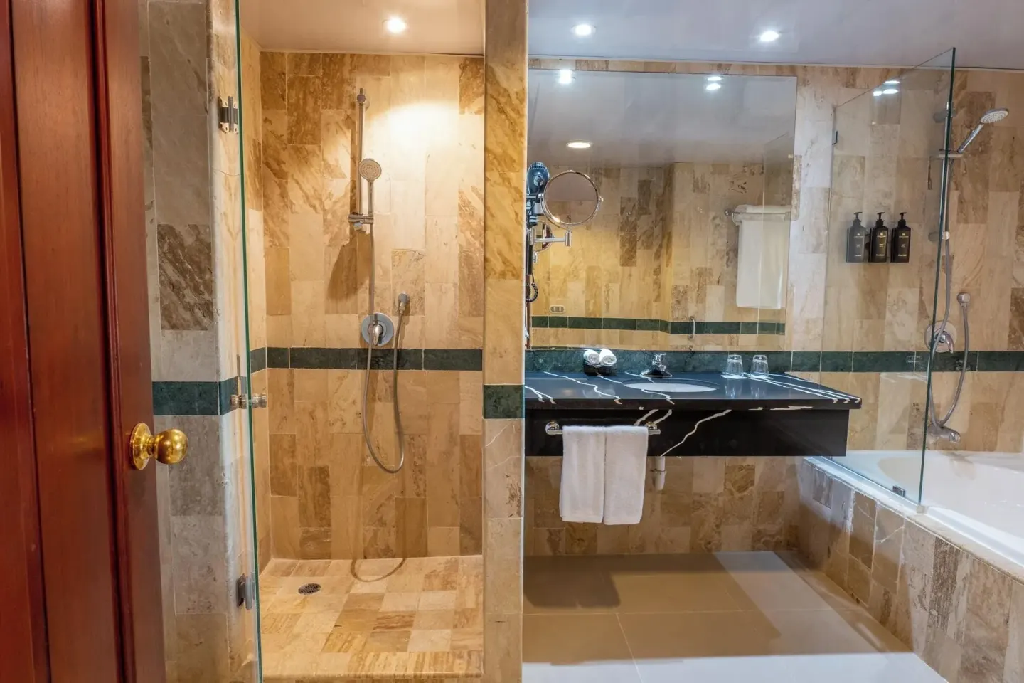Guest bathroom with glass shower and bathtub at Eurostars Grand Cayacoa.