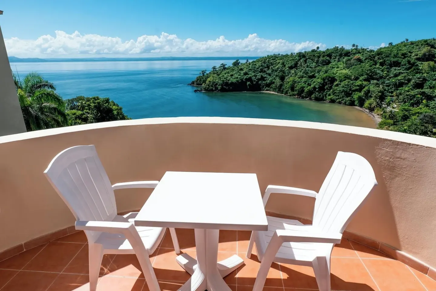 Balcony with table, two chairs, and bay view at Eurostars Grand Cayacoa.