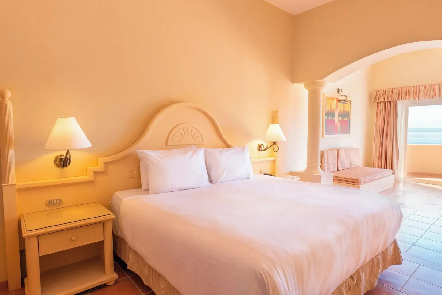 Guest room king bed with ocean-facing balcony at Eurostars Grand Cayacoa.