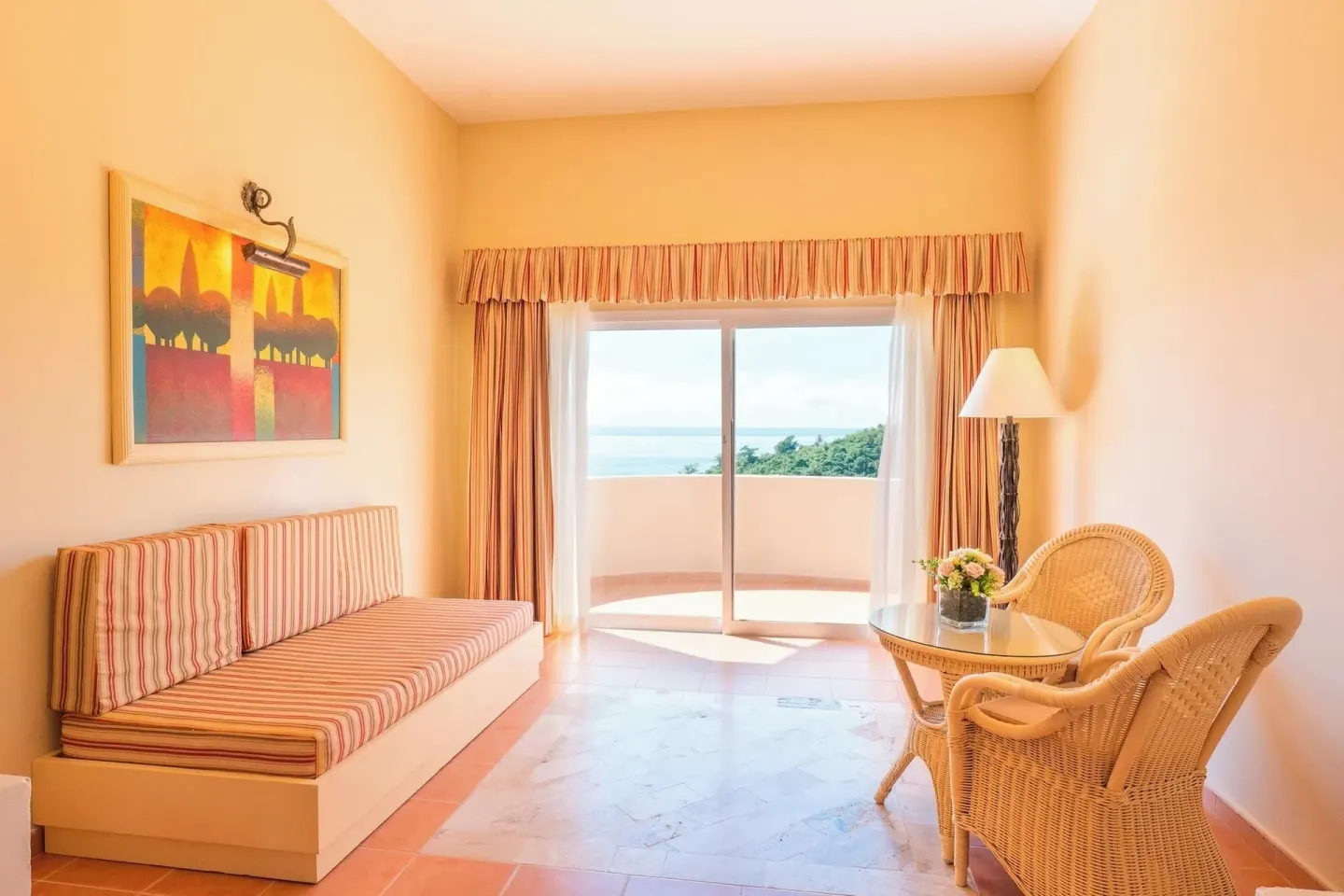 Guest room sitting area with balcony and ocean view at Eurostars Grand Cayacoa.