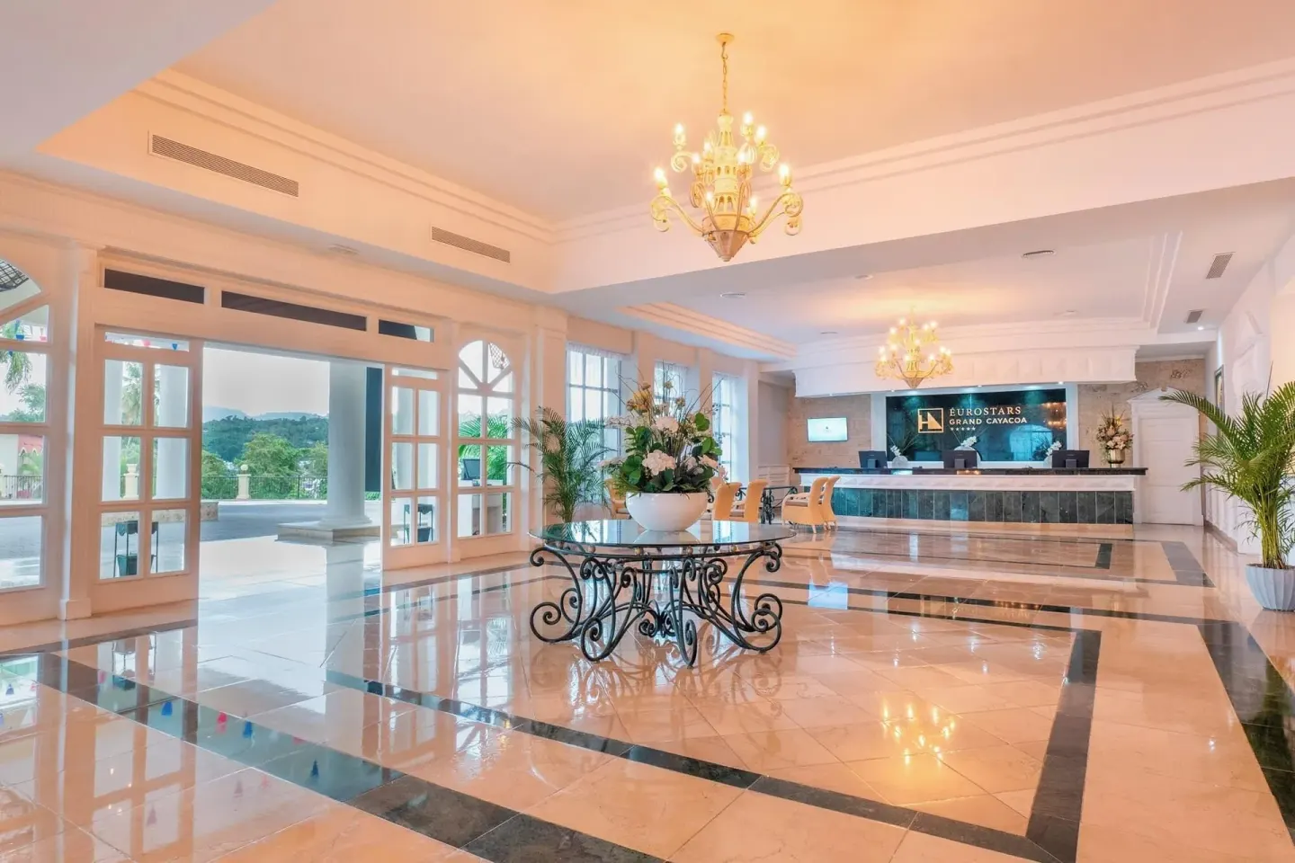 Bright lobby with marble floors and reception desk at Eurostars Grand Cayacoa.