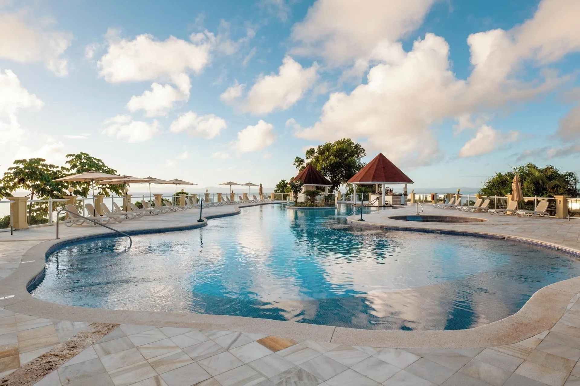 Main pool with curved edges and poolside loungers at Eurostars Grand Cayacoa.