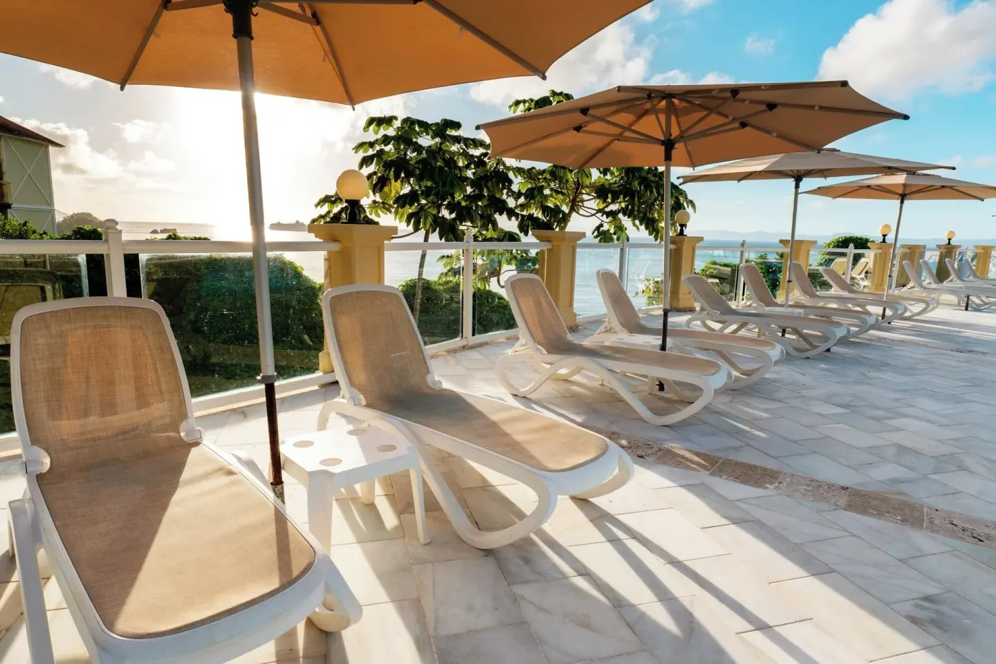 Sun loungers and umbrellas on an oceanview terrace at Eurostars Grand Cayacoa.
