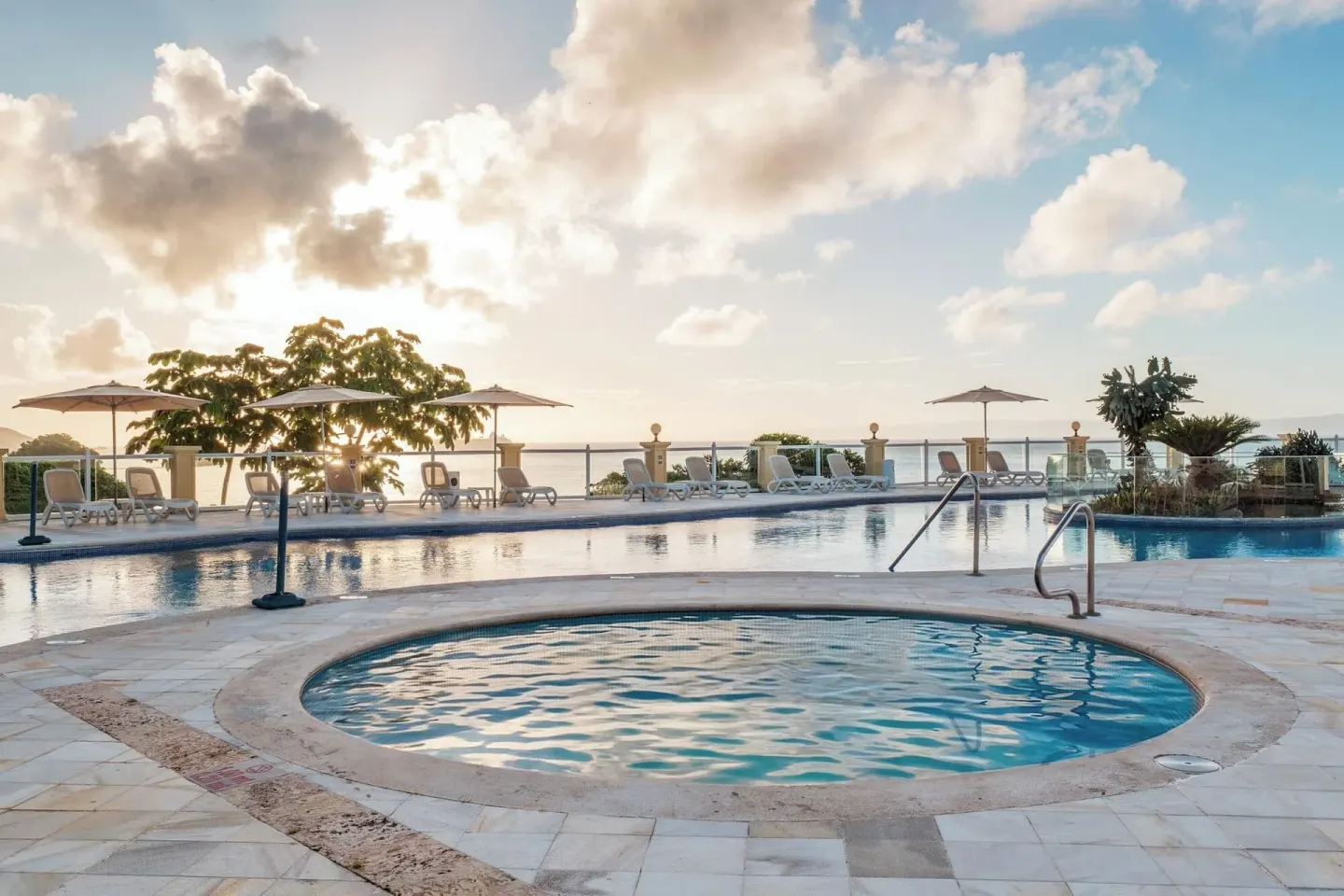 Pool deck with round wading pool and ocean backdrop at Eurostars Grand Cayacoa.