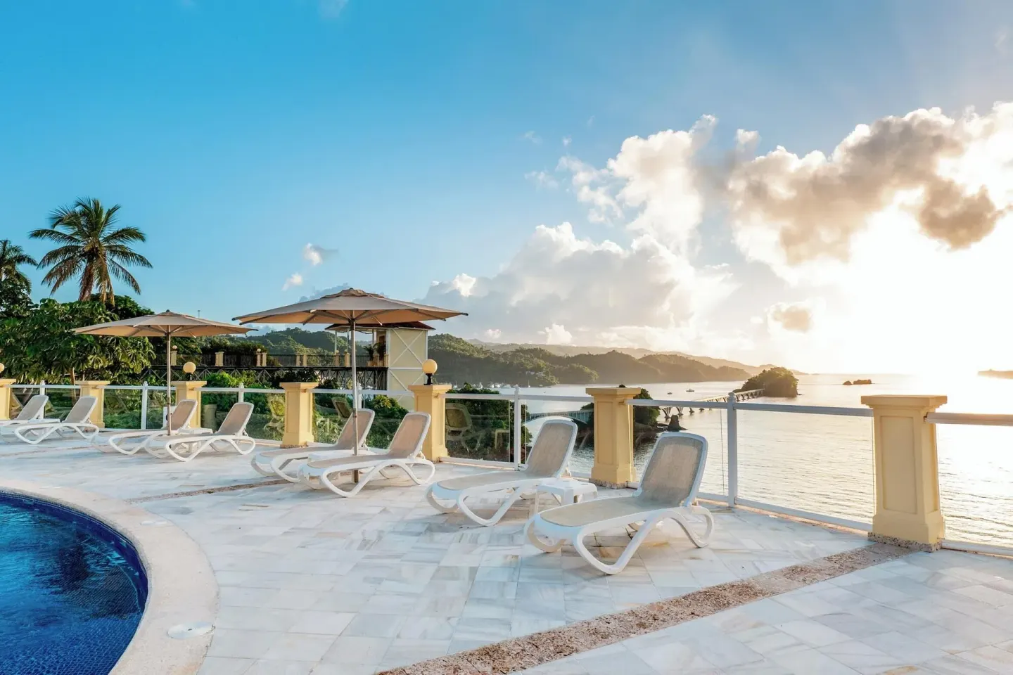 Pool terrace with loungers and bay views at Eurostars Grand Cayacoa.