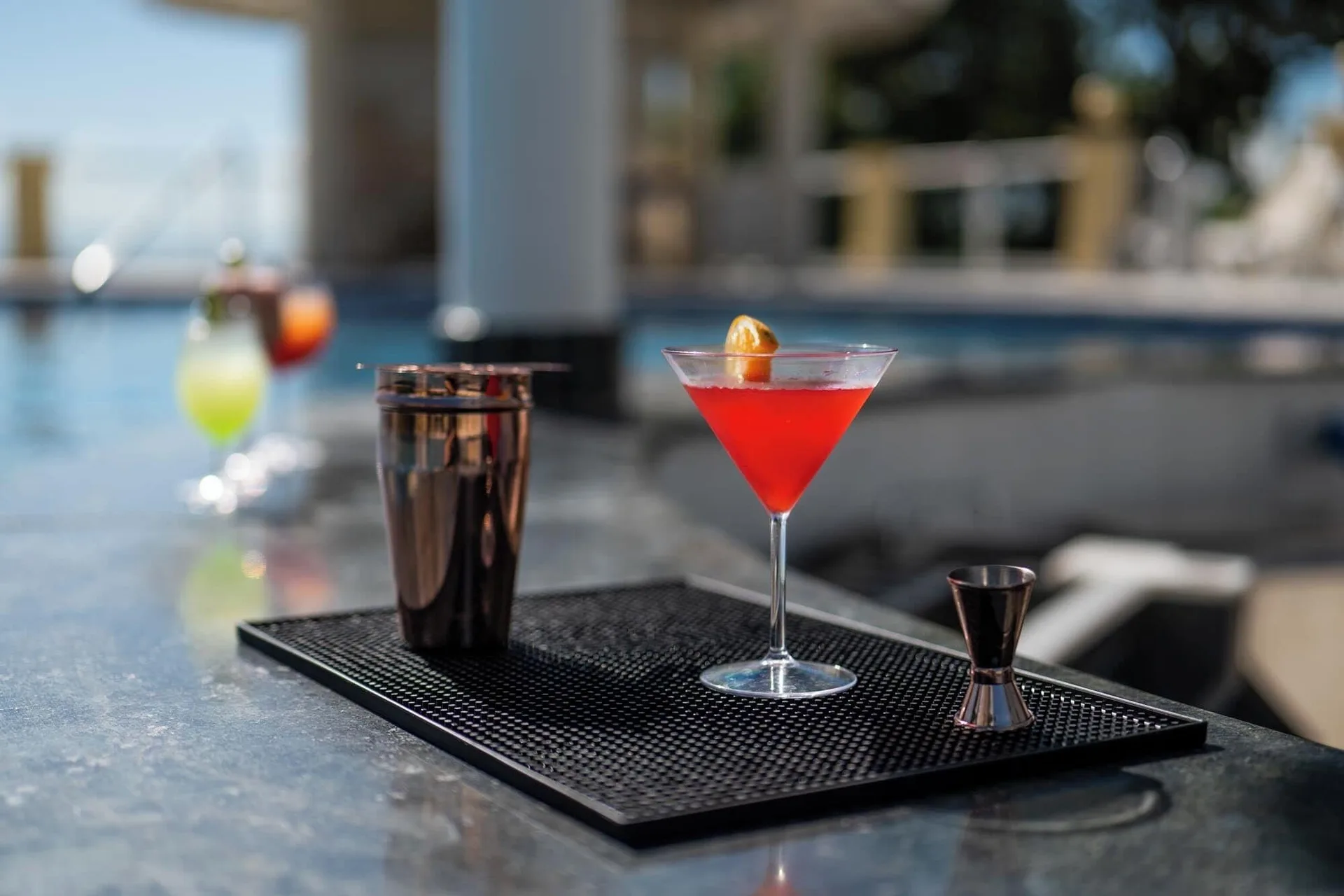 Red cocktail with bar tools on a poolside counter at Eurostars Grand Cayacoa.