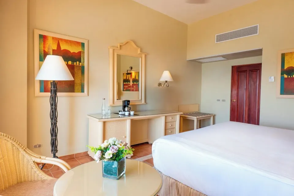 Deluxe Room Sea View dresser and king bed at Eurostars Grand Cayacoa.