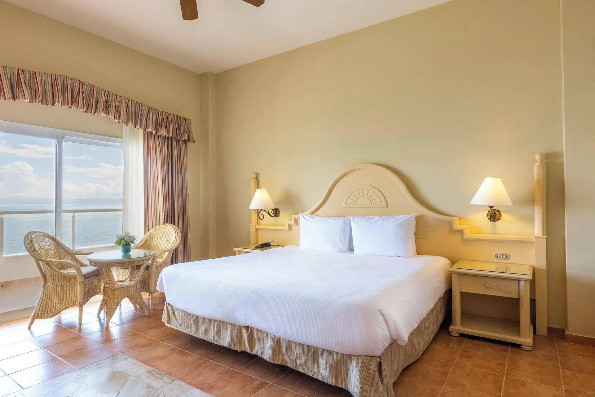 Deluxe Room Sea View king bed and window seating at Eurostars Grand Cayacoa.