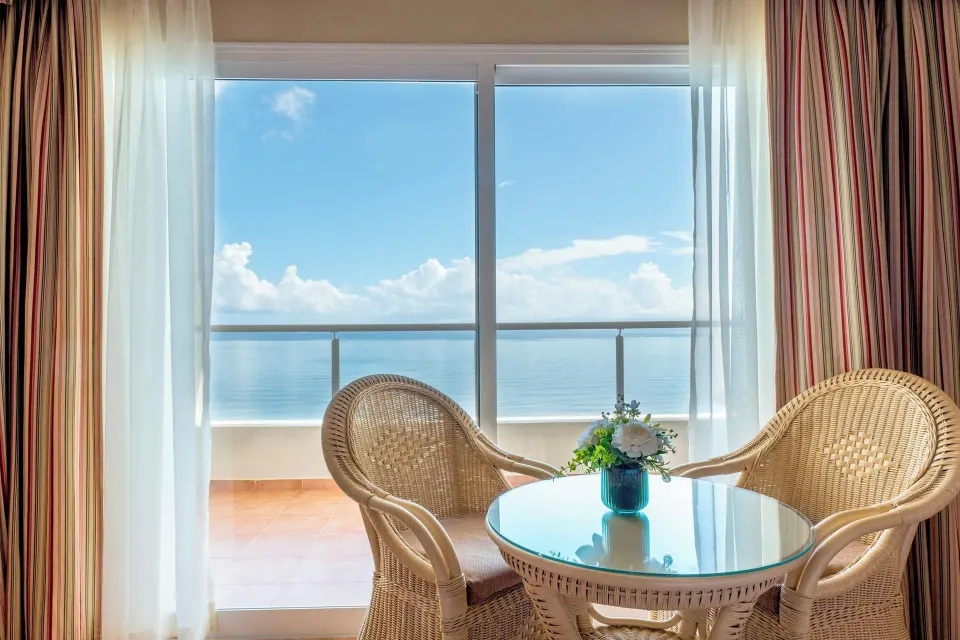 Deluxe Room Sea View sitting area and balcony view at Eurostars Grand Cayacoa.