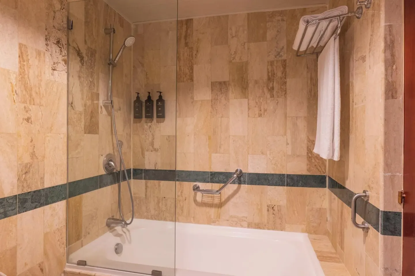 Bathtub and glass shower screen in a Deluxe Room bathroom at Eurostars Grand Cayacoa.