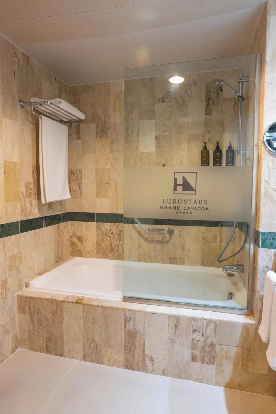 Deluxe Room bathtub with glass screen and tiled walls at Eurostars Grand Cayacoa.