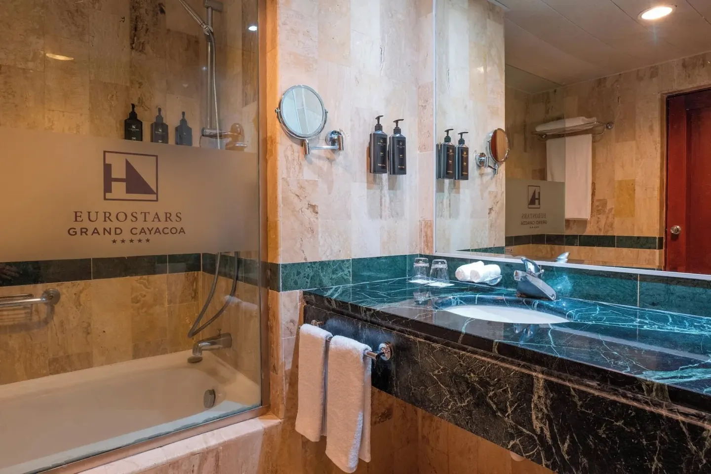 Deluxe Room bathroom vanity and glass-enclosed tub at Eurostars Grand Cayacoa.