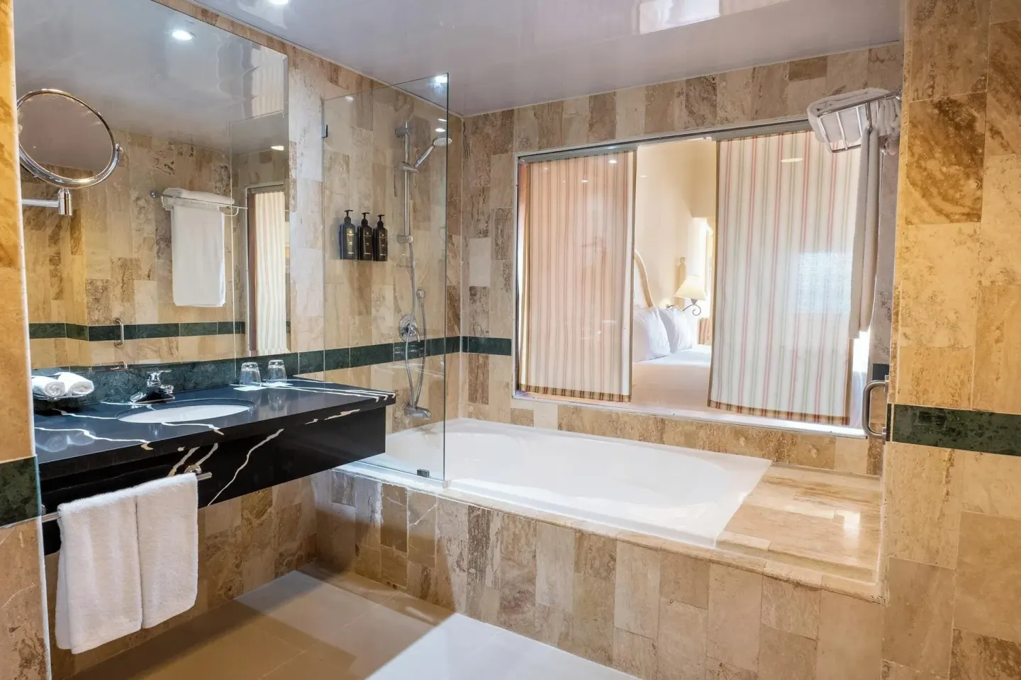 Room Sea View bathroom with bathtub and window to the bed at Eurostars Grand Cayacoa.