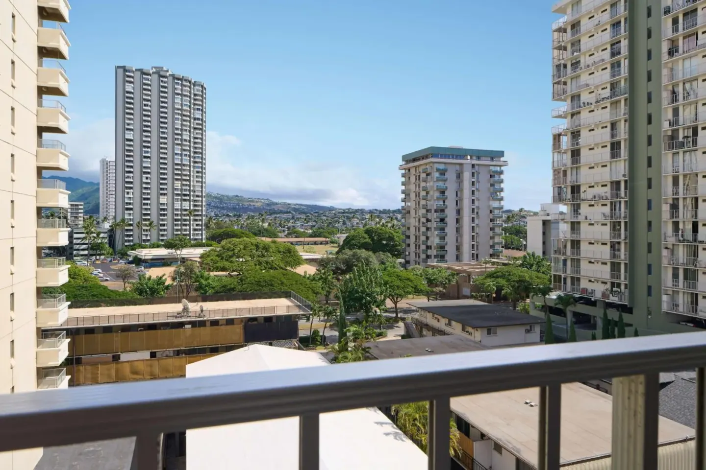 Balcony view of Waikiki high-rises and hills at Ewa Hotel Waikiki.