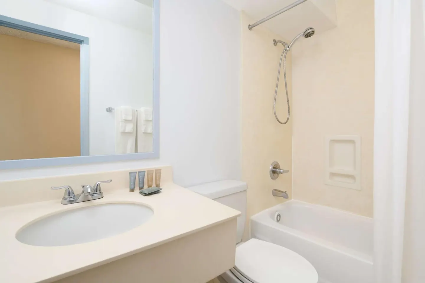 Guest bathroom with vanity and tub-shower at Ewa Hotel Waikiki.