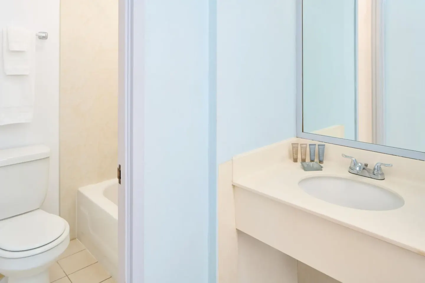 Bathroom vanity, toilet, and tub area at Ewa Hotel Waikiki.