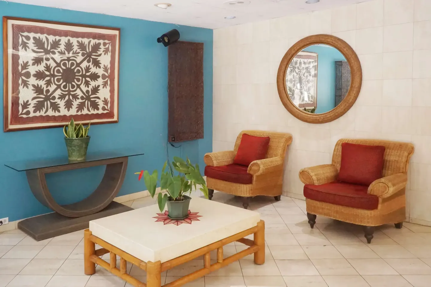Lobby seating area with wicker chairs and tropical decor at Ewa Hotel Waikiki.