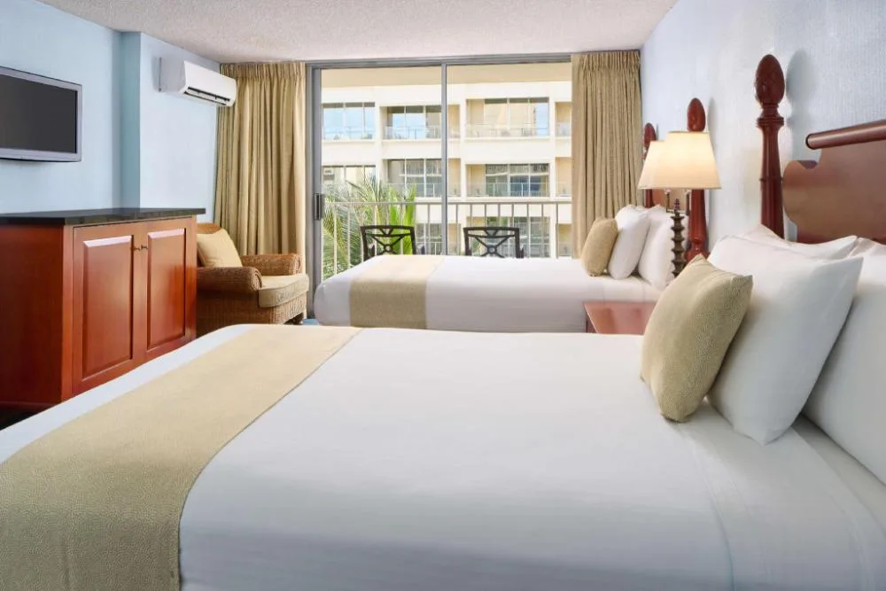 Studio with kitchenette and balcony room with two beds at Ewa Hotel Waikiki.