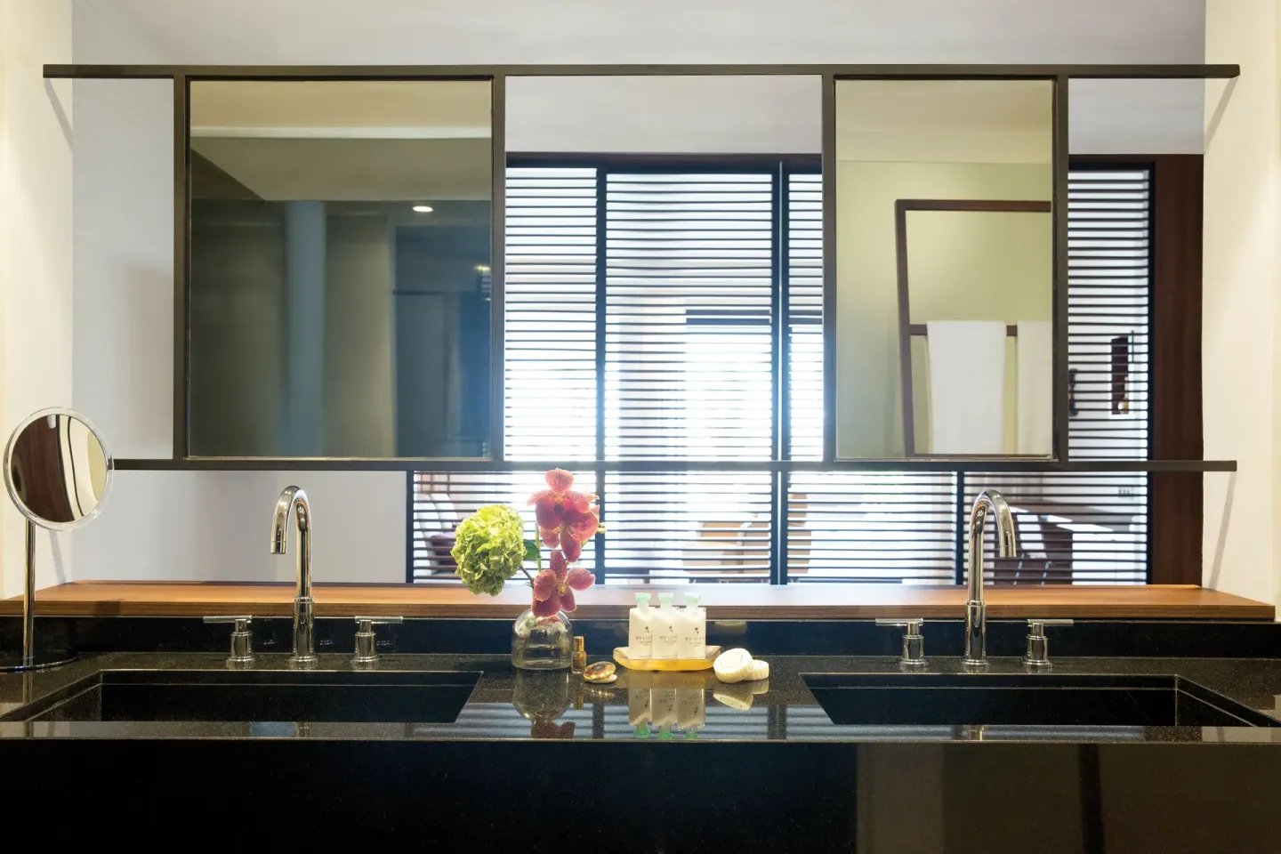 Double vanity bathroom with black stone counters at Excellence El Carmen.