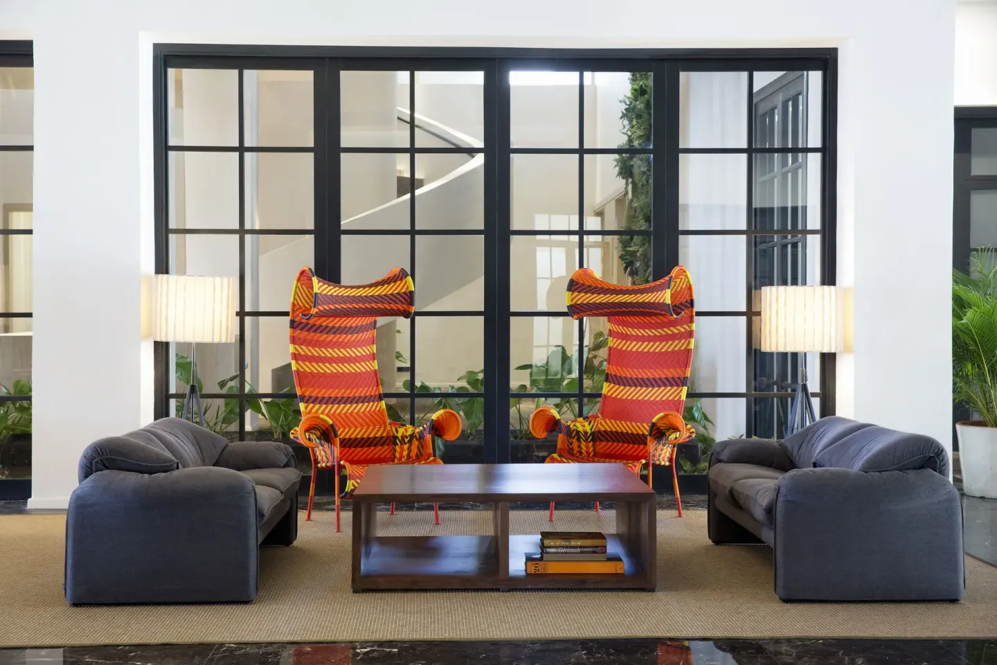 Lobby seating area with colorful high-back chairs at Excellence El Carmen.