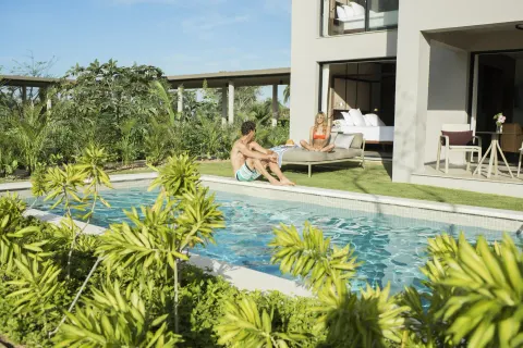 Ground-floor suite patio beside a swim-up pool at Excellence El Carmen.