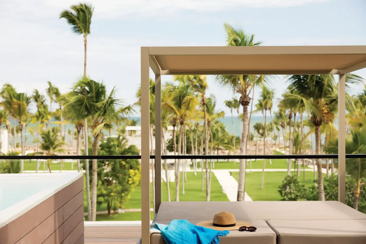 Terrace Suite plunge pool and daybed with palm and ocean views at Excellence El Carmen.