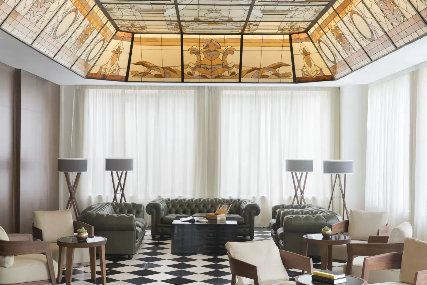 Lounge seating under a decorative stained-glass ceiling at Excellence Playa Mujeres.