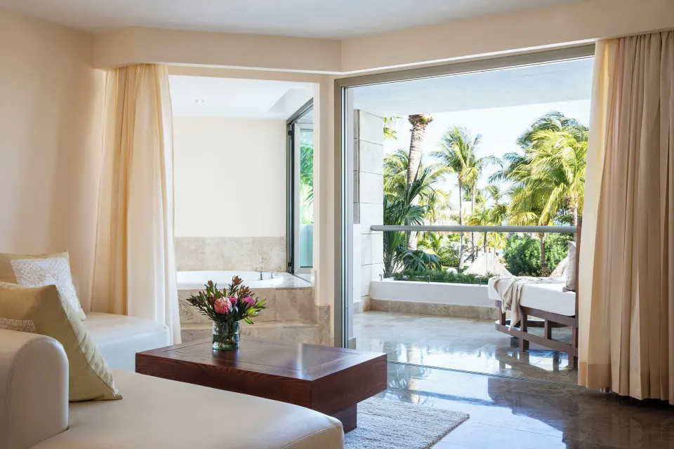 Junior Suite Spa or Pool View seating area opening to a balcony at Excellence Playa Mujeres.