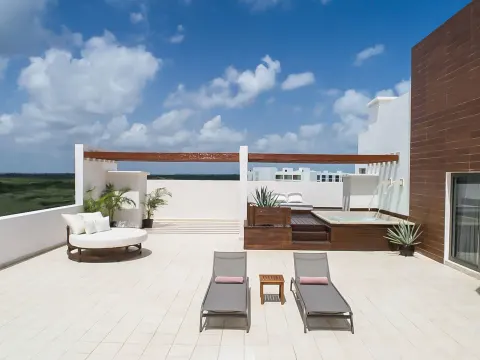 Terrace Suite plunge pool terrace with loungers and daybed at Excellence Playa Mujeres.