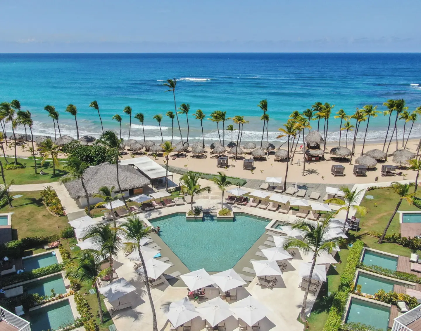 Aerial view of beachfront pool and cabanas at Excellence Punta Cana.