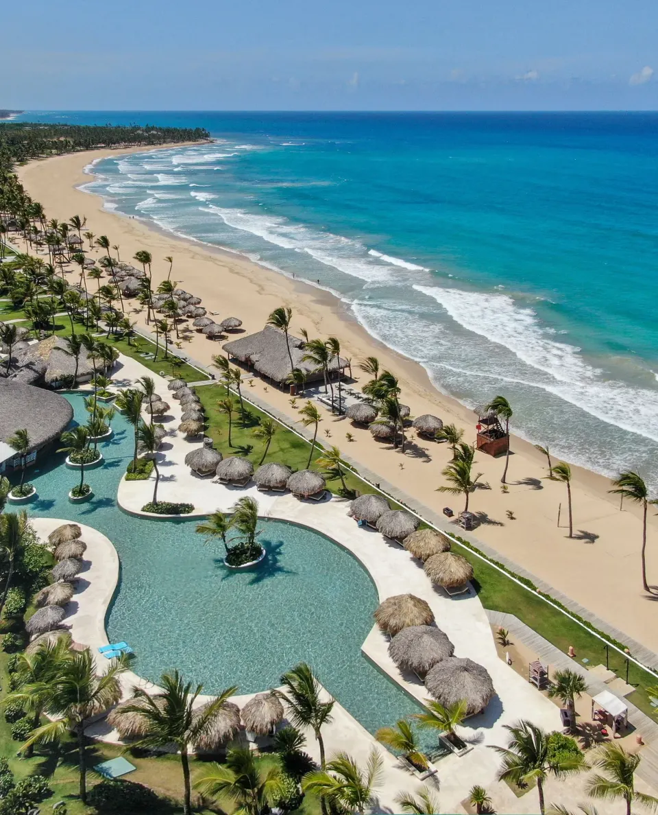 Aerial view of pools, palapas, beach, and ocean at Excellence Punta Cana.