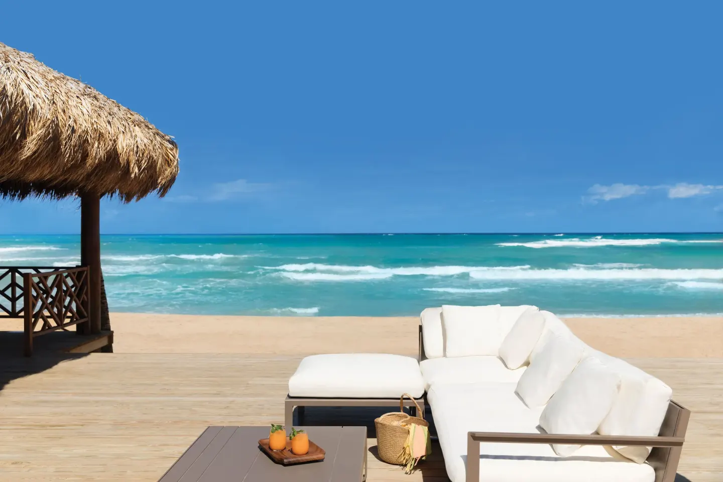 White outdoor sofa on a beachfront deck at Excellence Punta Cana.