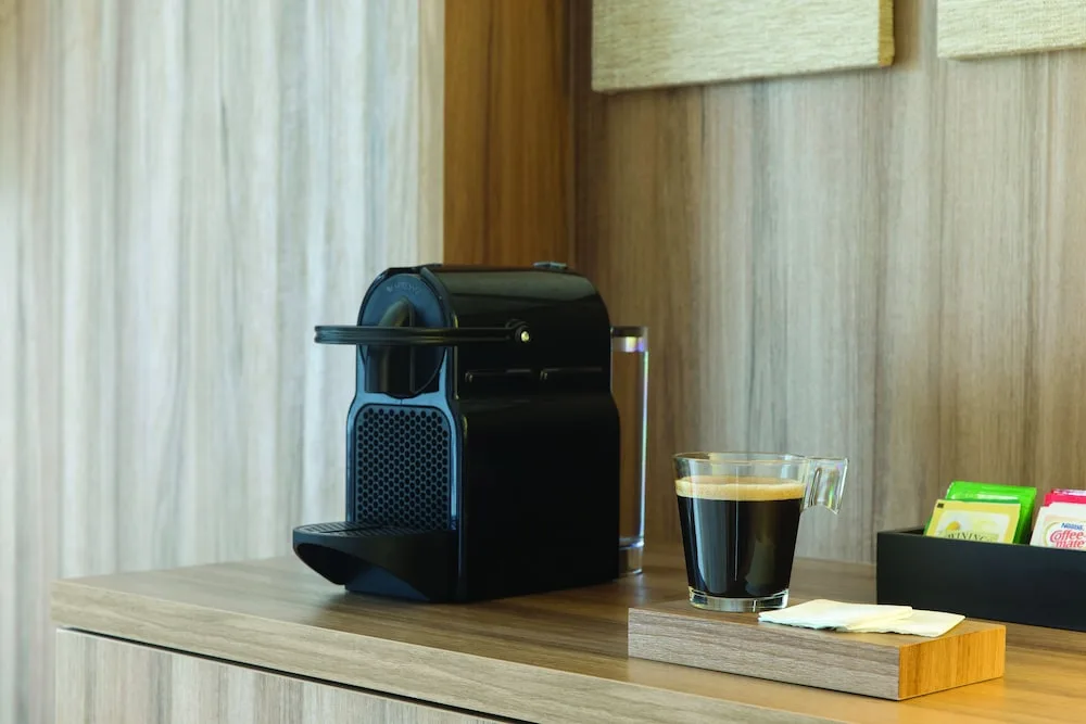 In-room coffee station with espresso machine and cup at Excellence Punta Cana.