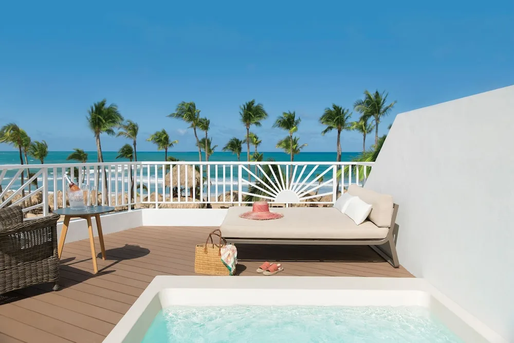 Ocean-view terrace with plunge pool and daybed at Excellence Punta Cana.