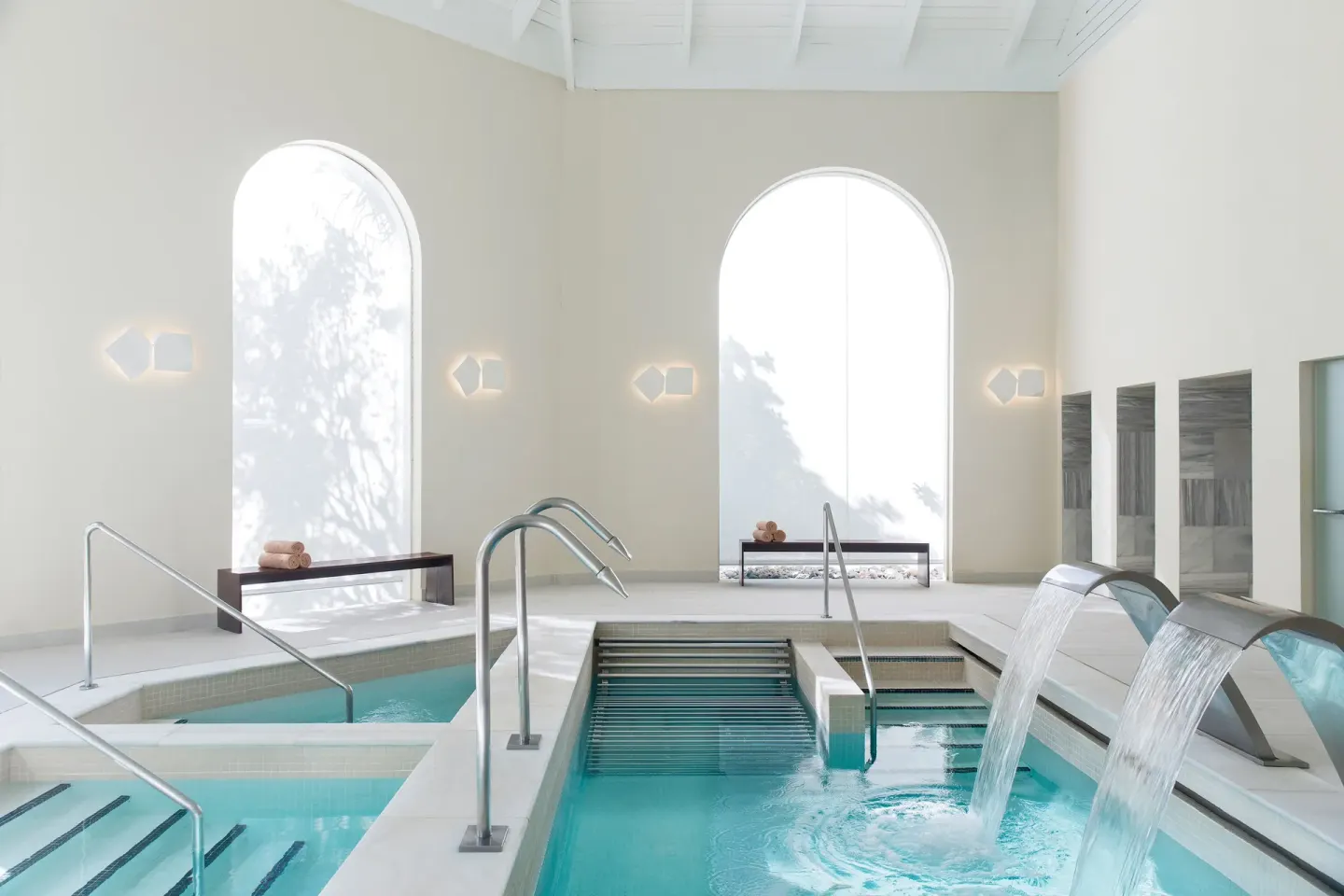 Bright spa hydrotherapy pools with water features at Excellence Punta Cana.