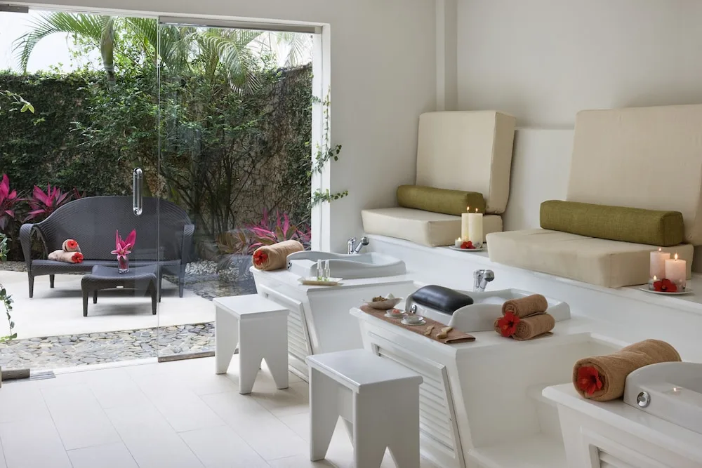 Spa pedicure chairs with foot baths and garden patio at Excellence Punta Cana.