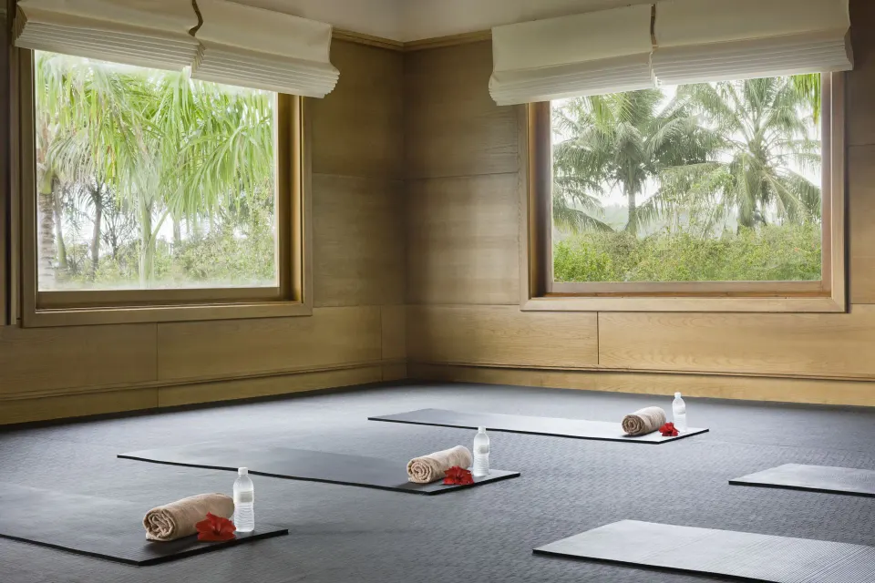 Yoga studio with mats, towels, water bottles, and palm views at Excellence Punta Cana.