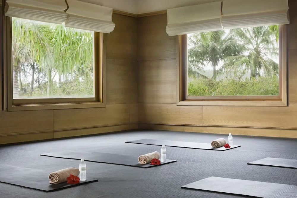 Yoga mats with towels and water bottles in a studio at Excellence Punta Cana.