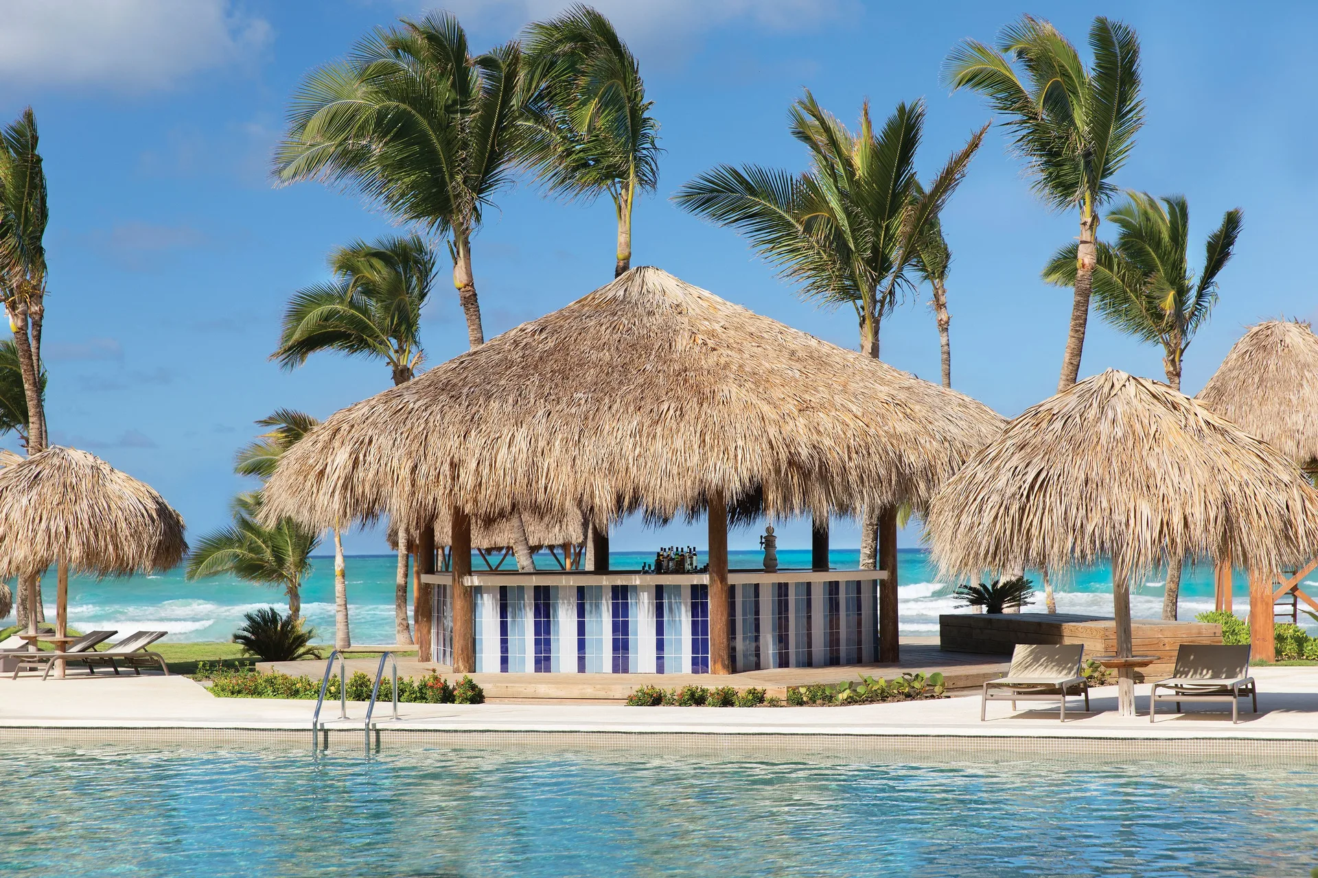 Thatched pool bar beside the beach at Excellence Punta Cana.