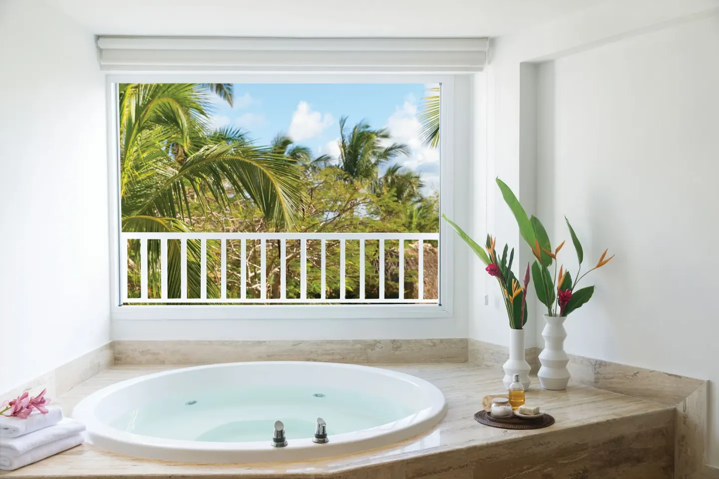 Whirlpool tub in the Excellence Punta Cana at Excellence Punta Cana facing palms.