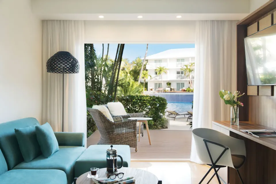 Excellence Punta Cana sitting area with terrace and pool view at Excellence Punta Cana.